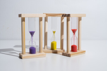 Hourglass on a colored background with space for text. Concept of lack of time and deadline.