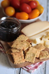 planche apéritive: fromage, confiture, crackers et tomates cerise