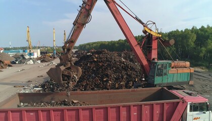 Excavator Loading Scrap Metal into Truck at Industrial Recycling Facility