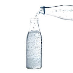 Photo of clear bottle of sparkling water with bubbles, isolated on transparent background, with water pouring from another bottle