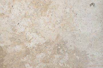 Light travertine wall texture with natural imperfections
