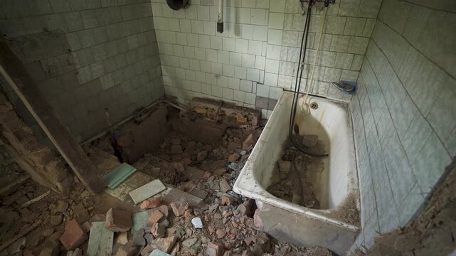 An old house being torn down. Cracked walls, fall bricks. Scene of destruction and rebuilding.