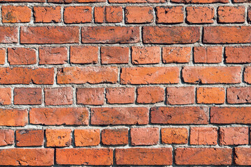 Brown, red brick wall background with cement seams. Texture close-up.