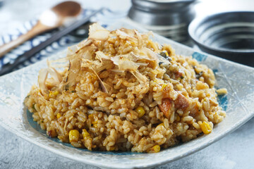 Eel Fried Rice with Bonito Flakes in plate closeup side view of Japanese Cuisine and Main Course