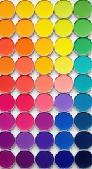 Overhead shot of a vibrant eyeshadow palette displaying a rainbow of colors in a circular arrangement offering a diverse selection