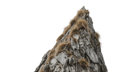 Majestic mountain peak with rugged rock face and windswept grass perfect for adventure, climbing or nature themes. Ideal for travel and outdoor campaigns