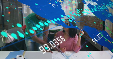 Colleagues reviewing printed documents on white desk in modern office, with digital data overlays