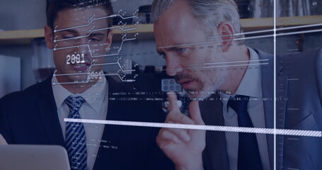 Pointing senior professional and partner analyzing laptop screen in office corner with data overlay