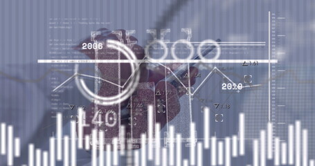 Interacting senior Japanese man's hand holding stylus drawing financial charts on screen in office