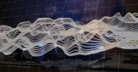 Displaying semi-transparent grid and white dotted waveform hovering over office desk, with keyboard