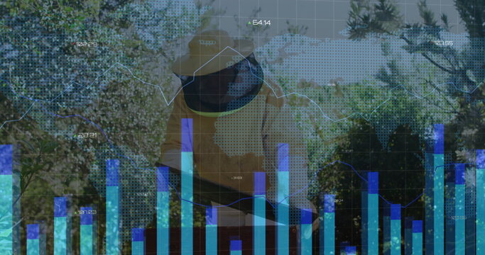 Inspecting beekeeper wearing yellow suit and veil at apiary, with honeycomb frame and data overlays