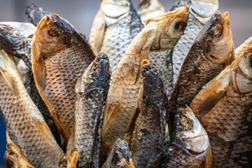 Closeup of traditional dried fish for sale at local market – natural preserved seafood background