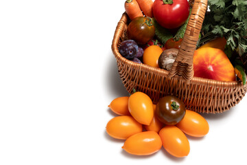A bright basket with vegetables and fruits on a white background. Organic products, natural colors, healthy lifestyle. Isolated on white background