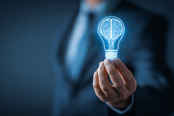 Business person holds glowing blue brain in lightbulb. Signifies ideas, intelligence, AI. Use for concepts, technology, science, creativity, innovations.