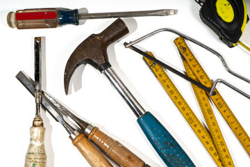 Carpenter tools lying on white background ready for building and repairing
