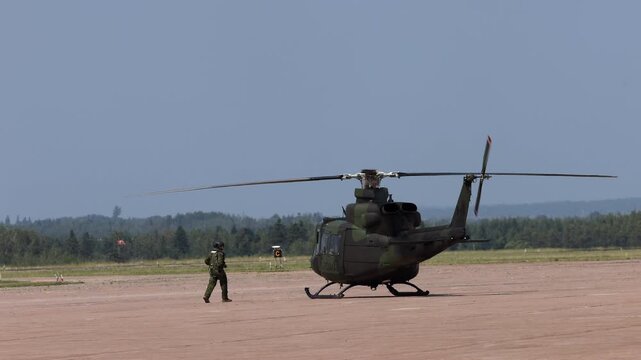 Summerside Prince Edward Island Canada - July 15th 2025 - Canadian Armed Forces CH-146 Griffon Helicopter preparing for take off with pilot outside