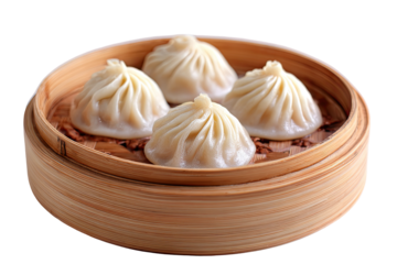 Four steamed dumplings in a bamboo steamer basket