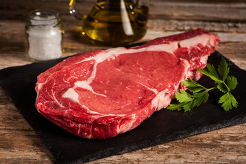 Veal entrecote on a stone plate with a rustic background, close-up.