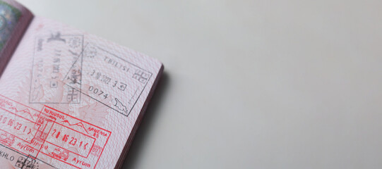 Horizontal travel banner. Tourist document on table. Close up part of pages of Russian foreign passport with visas, border stamps, permits to enter countries. Concept of journey, visit, trip, flight