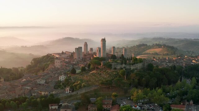 Beautiful landscape with the medieval town of San Gimignano at sunrise in Tuscany, province of Siena, Italy. Aerial view.