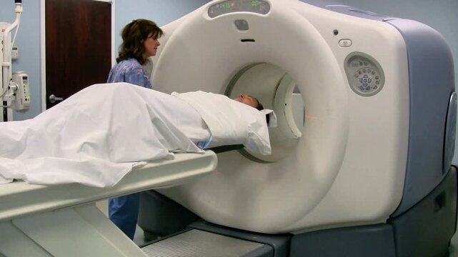 PET Scan Technologist Positioning Patient into PET CT Scanner
