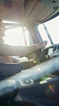 positive male truck driver inside in cabin