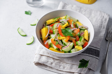 Cucumber red onion mango red bell pepper salad in a bowl