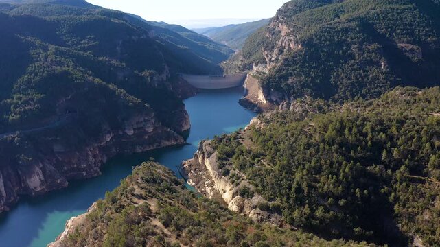 Aerial view of the Llosa del Cavall dam, with a double-round arch, is 122 m high, was completed in 1997 and is located in a wooded and sparsely populated area called Llosa del Cavall, Spain.