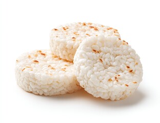 Three round, lightly browned rice cakes stacked, showcasing puffed rice texture and slight caramelization on a white background
