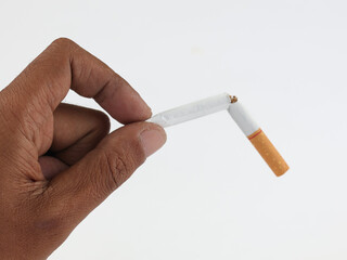 Male hand holding broken cigarette, refusing cigarette and lung healthy concept. Isolated white background 
