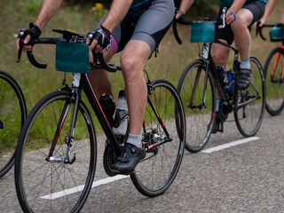 Naklejka premium Close-up of competitive cycling with aerodynamic time trial bikes and racing equipment during event