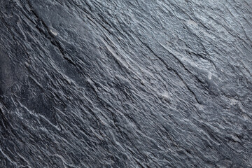 Close-up of weathered gray stucco exterior wall displaying textured finish and architectural surface detail