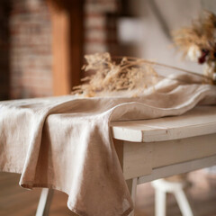 Beige Linen Tablecloth and Dried Plants on White Wood