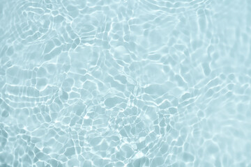 Reflections of blue water or cosmetic moisturiser toner or lotion light with scattered sun texture