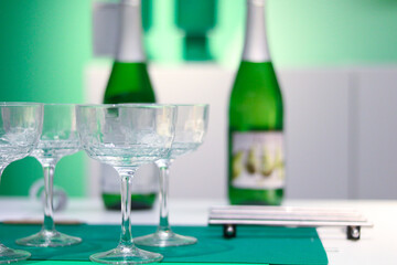 Elegant Champagne Glasses with Green Bottles