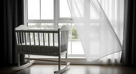 A white baby crib sits near a window with blowing sheer curtains, indoors.