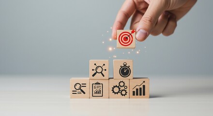 Hand Placing Target Block on Wooden Cubes Showing Business Strategy