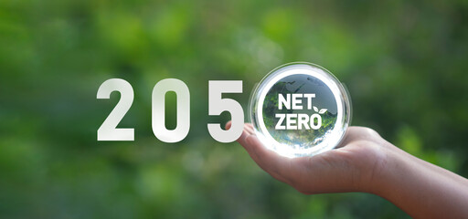 Net-zero and carbon-neutral greenhouse gas emissions concept, carbon dioxide emissions and 2050 green goals on a crystal globe.