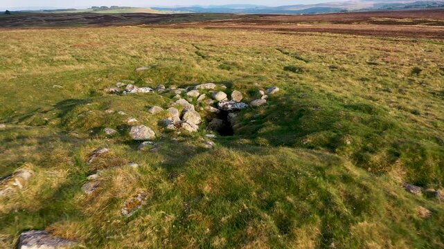 White Raise Bronze Age round cairn and burial cist on Moor Divock at NY 48887 22429. Neolithic Bronze Age landscape. Askham Fell, Cumbria, England. View to SE. 4k video fly out up