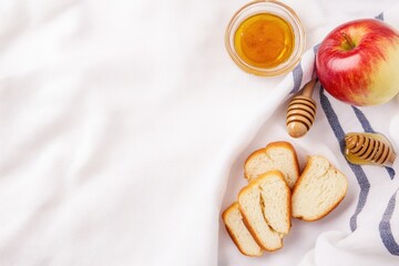 Minimalist flat lay of Yom Kippur symbols including apple, honey, challah and tallit in soft light