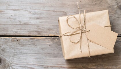 Wrapped Gift With Twine and Tag on Wooden Table with Rustic Texture