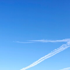 Clear blue sky with faint contrails