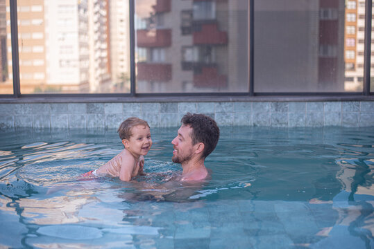 Dad and son in a rooftop pool