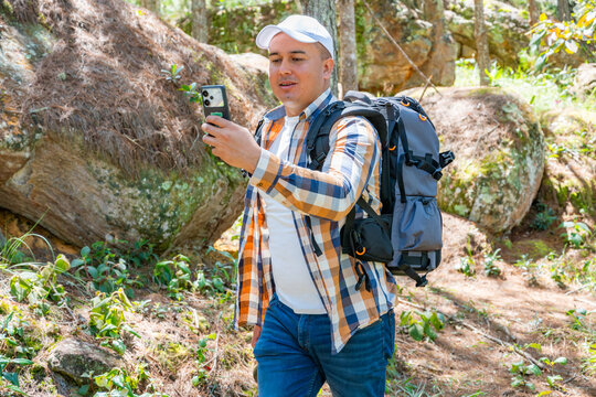 Hiker making a video call in the forest