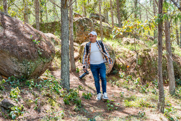 Photographer moving fast through forest while observing the landscape