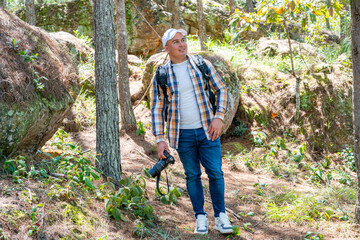 Smiling photographer admiring the forest canopy