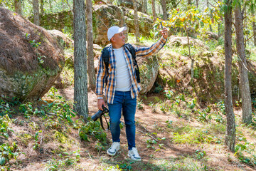 Photographer on video call while walking through forest