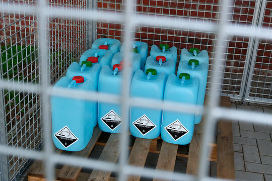 Pallet with large chemical containers in metal cage