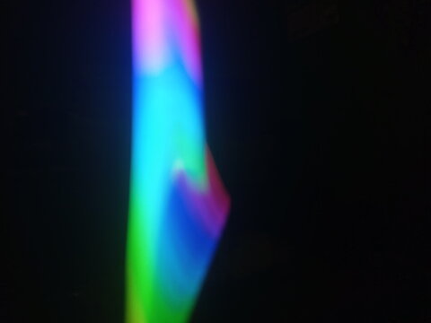 A multicolored abstract by moving strokes of light, creating bright, swirling streaks of rainbow-colored light on a dark background - Powered by Adobe