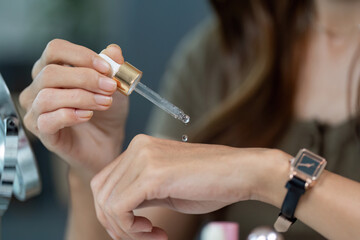 Applying Serum Woman Testing Skincare Product on Wrist